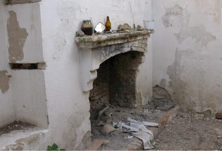 One of the original fireplaces in the neglected structure now restored